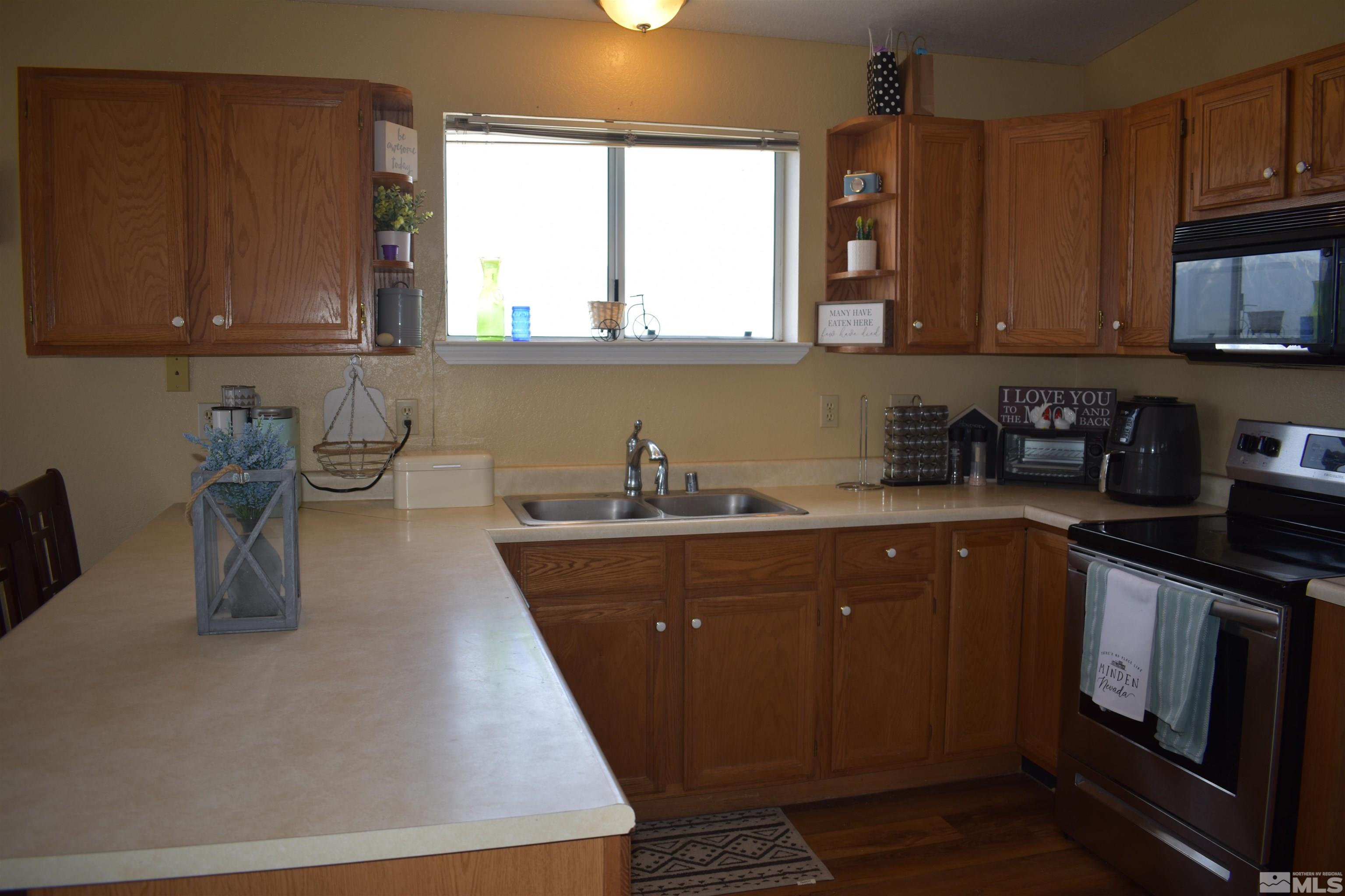 1737 Dee Jay Lane Minden, NV 89423 - Photo 22 of 40 a kitchen with sink a microwave and cabinets