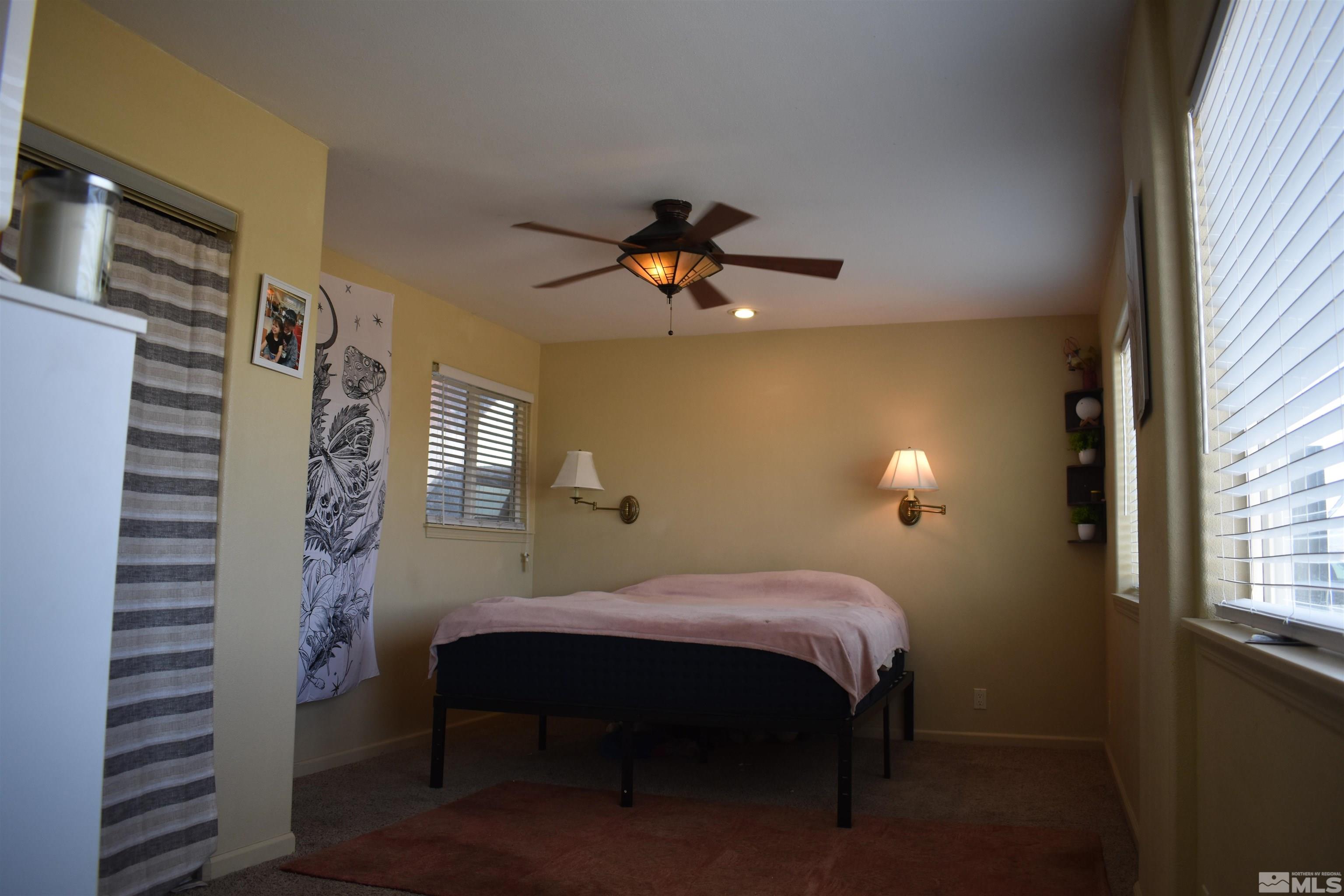 1737 Dee Jay Lane Minden, NV 89423 - Photo 23 of 40 a bedroom with a bed and a chandelier