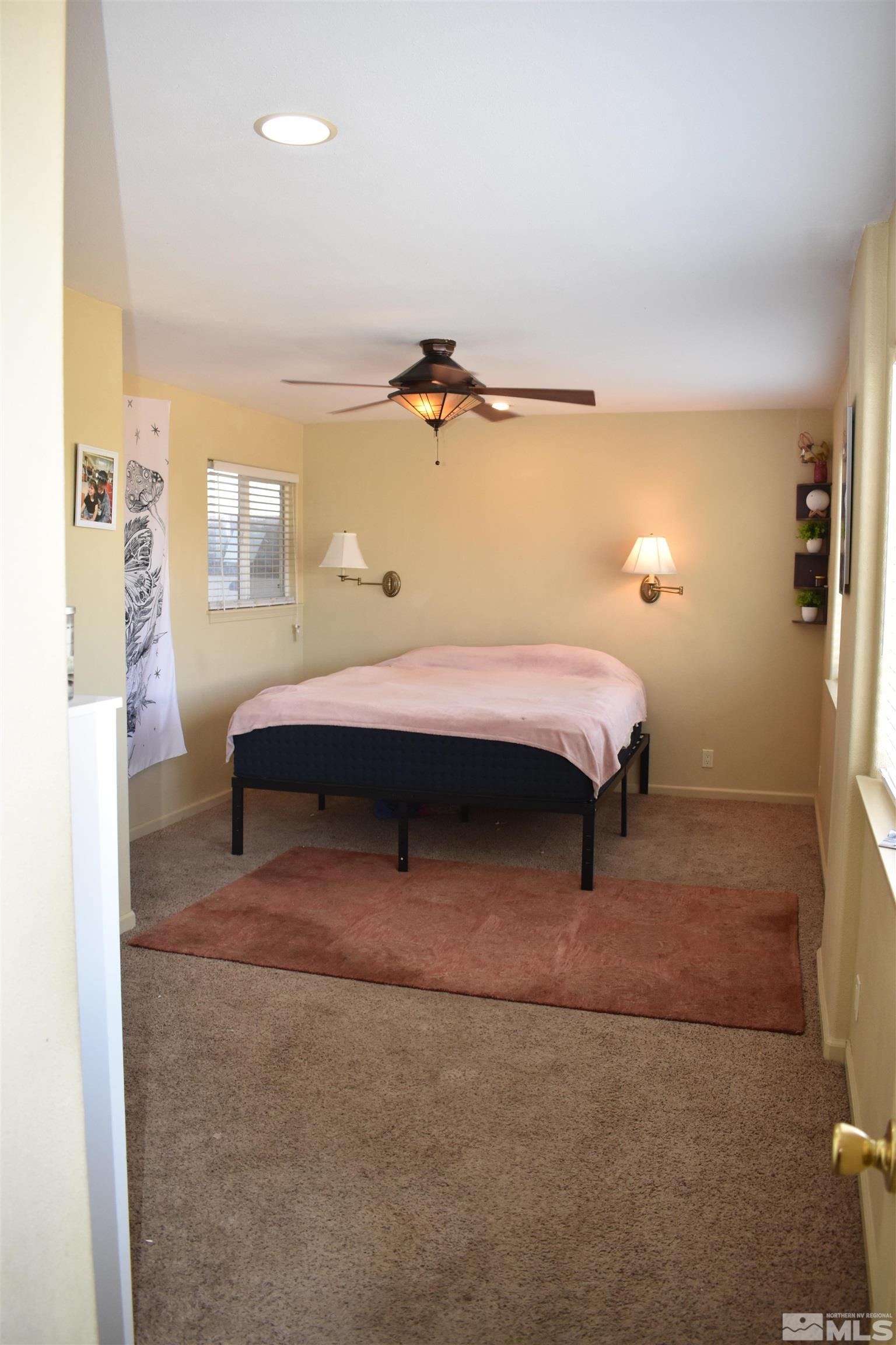 1737 Dee Jay Lane Minden, NV 89423 - Photo 24 of 40 a bedroom with a bed and a lamp with the bathroom