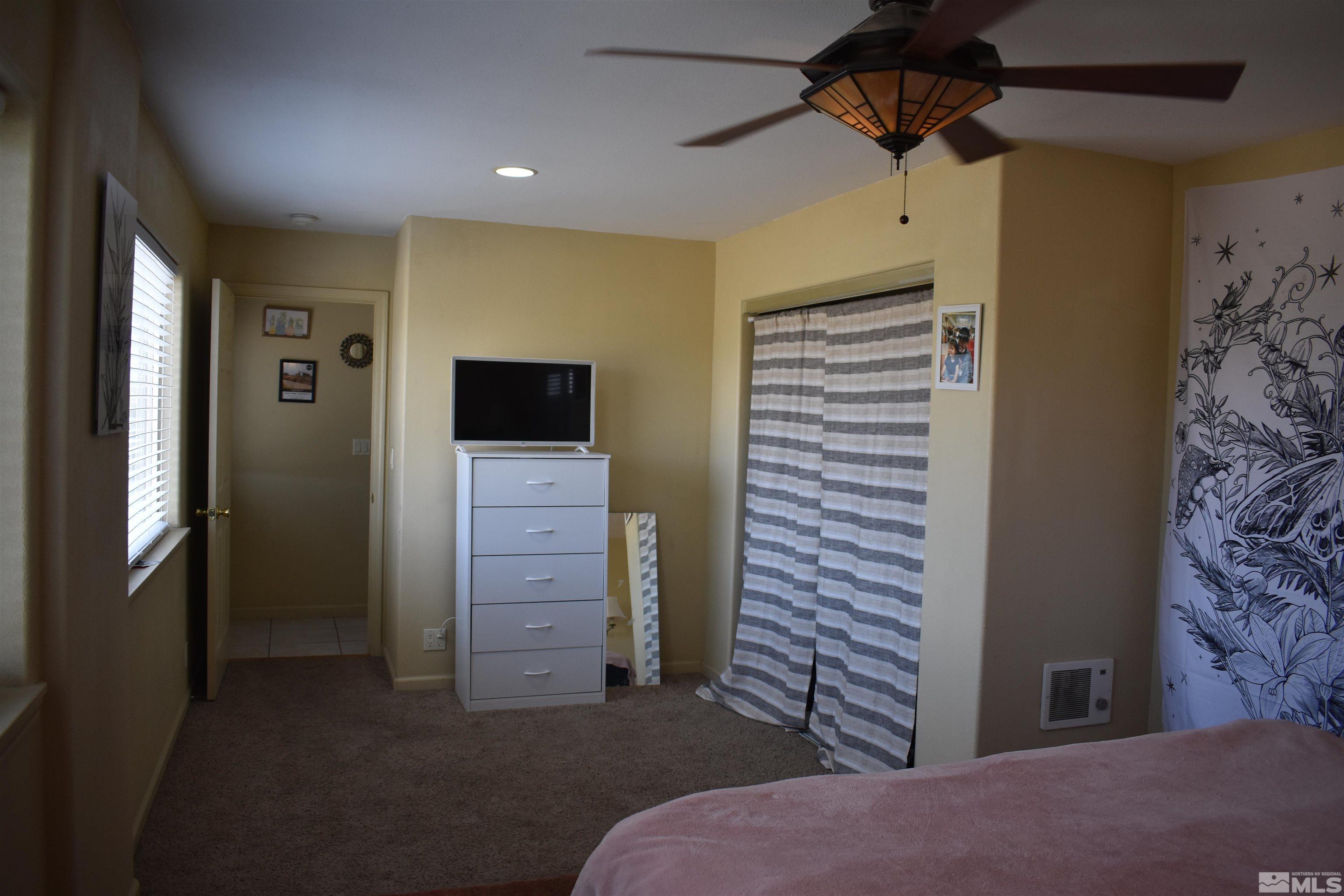 1737 Dee Jay Lane Minden, NV 89423 - Photo 25 of 40 a room that has a bed and a television in it