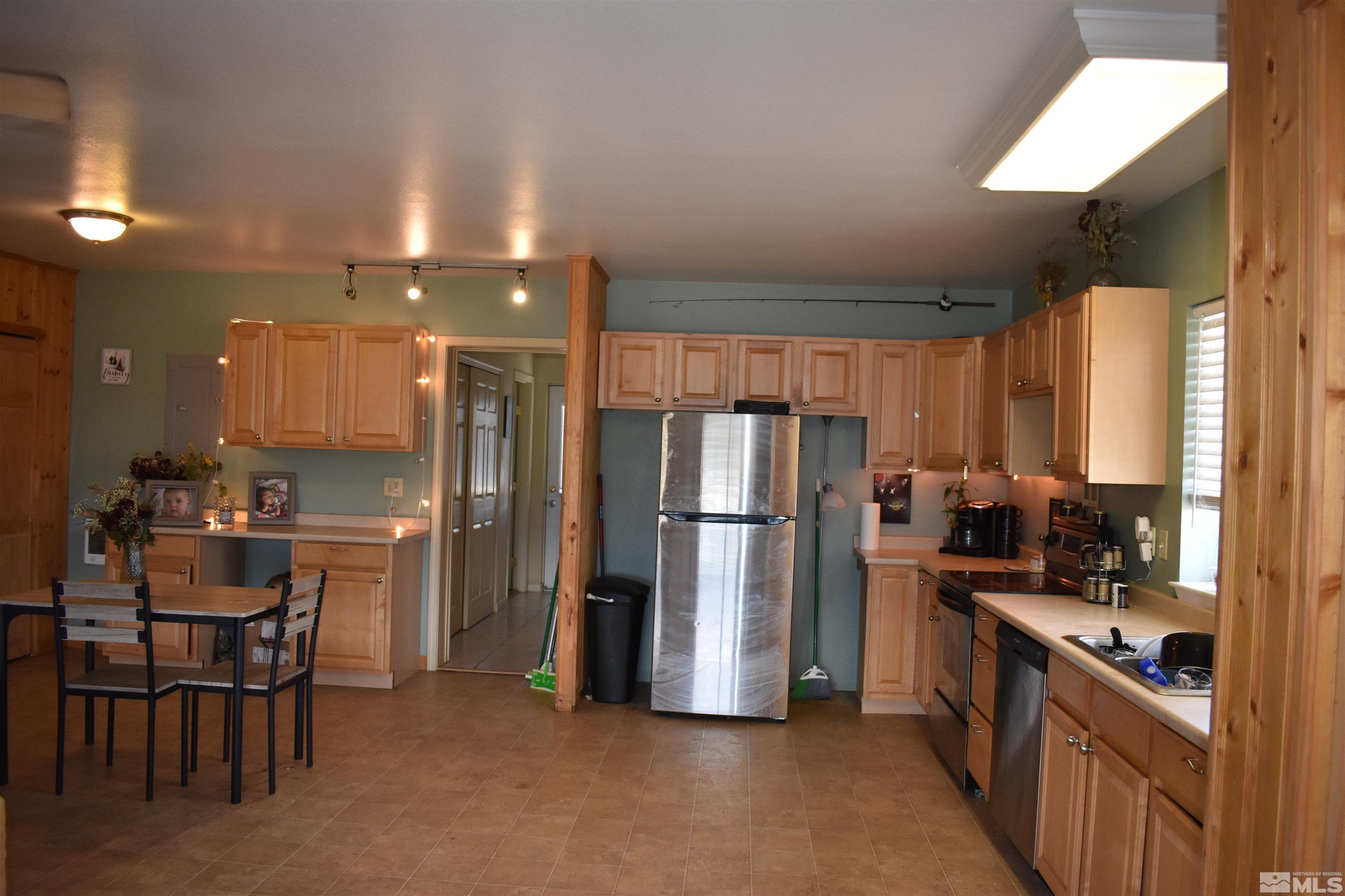 1737 Dee Jay Lane Minden, NV 89423 - Photo 8 of 40 a kitchen with refrigerator and chairs