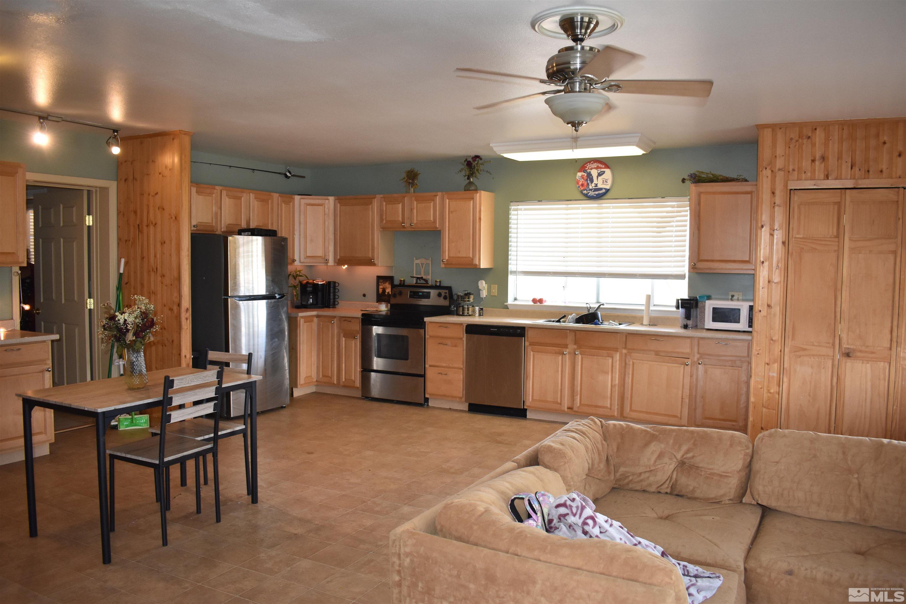 1737 Dee Jay Lane Minden, NV 89423 - Photo 9 of 40 a kitchen with stainless steel appliances kitchen island granite countertop a refrigerator and a stove top oven