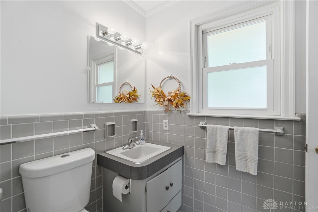 6119 Flemington Road Dayton, OH 45459 - Photo 29 of 76 This bathroom features a sleek vanity and a bright window, offering a refreshing start to your day.