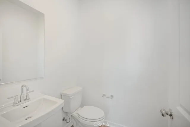a white toilet sitting next to a white sink