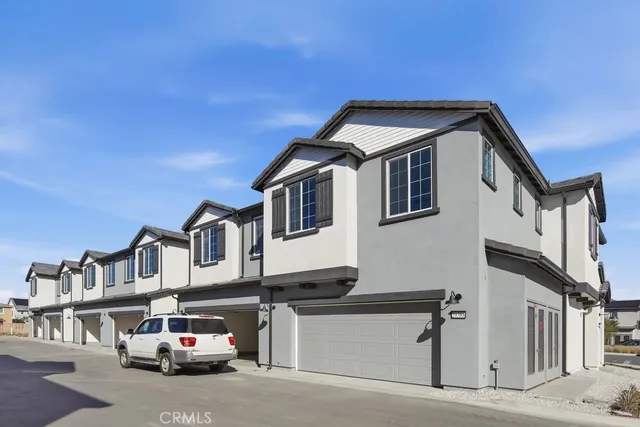 a car parked in front of a white house