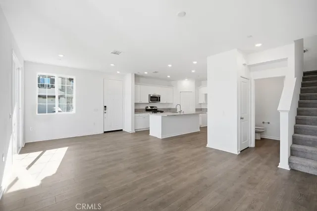 a view of a kitchen with a refrigerator and a sink