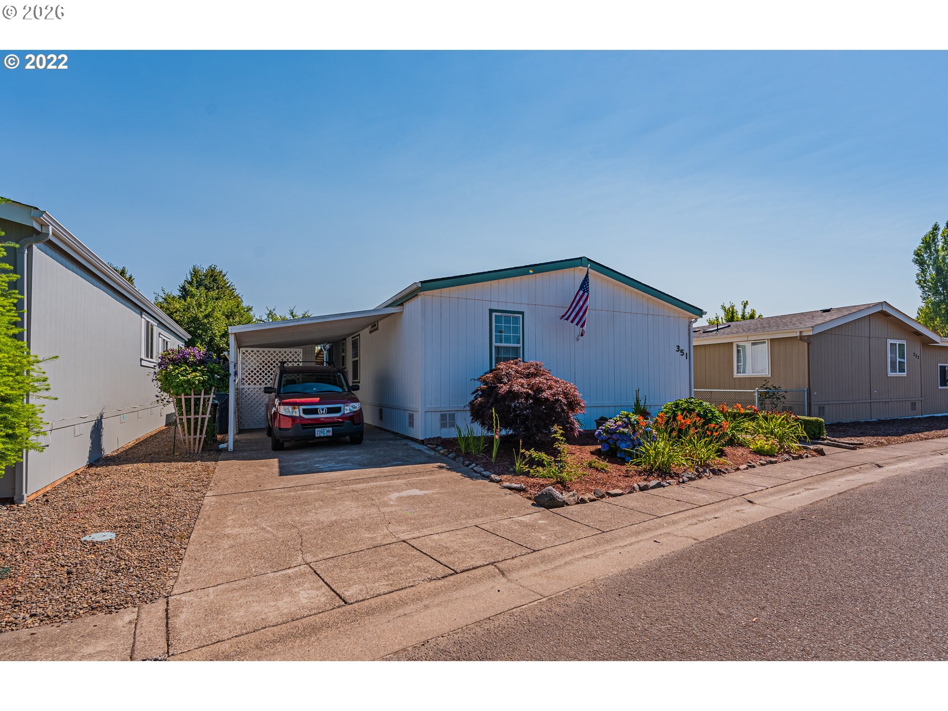 1699 North Terry Street, Unit 351 Eugene, OR 97402 - Photo 1 of 23 a view of a house with a yard and plants