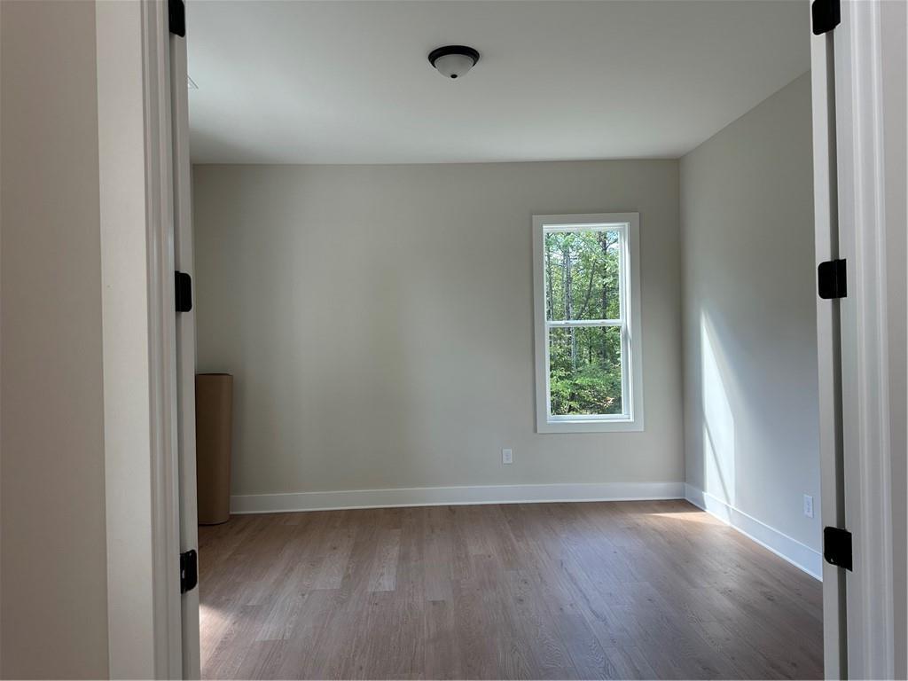 967 Cable Road Waleska, GA 30183 - Photo 11 of 27 an empty room with wooden floor and windows