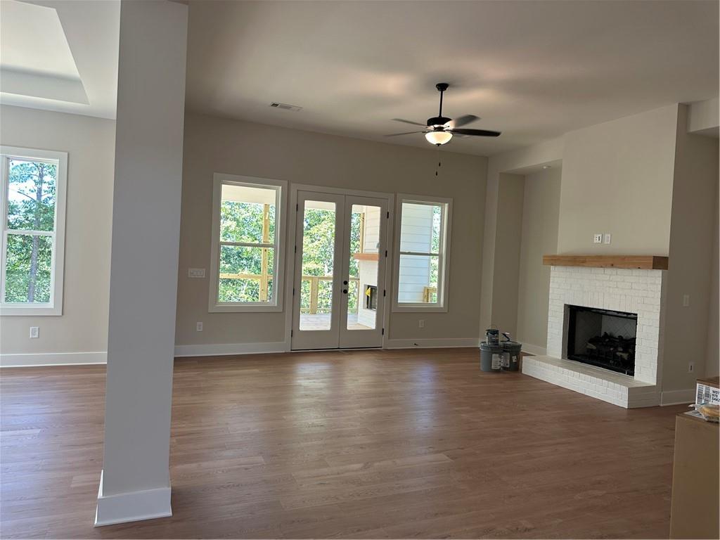 967 Cable Road Waleska, GA 30183 - Photo 16 of 27 an empty room with windows fireplace and a chandelier fan
