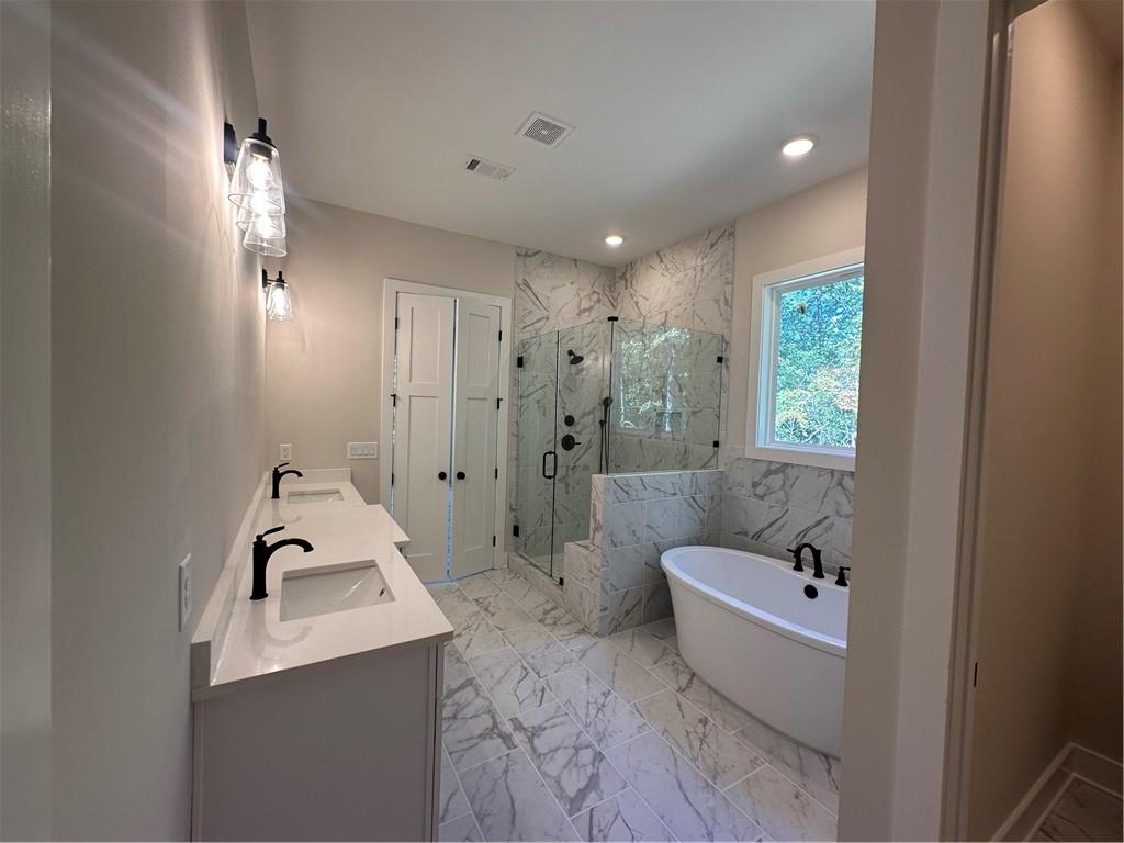 967 Cable Road Waleska, GA 30183 - Photo 19 of 27 a bathroom with a tub sink and mirror