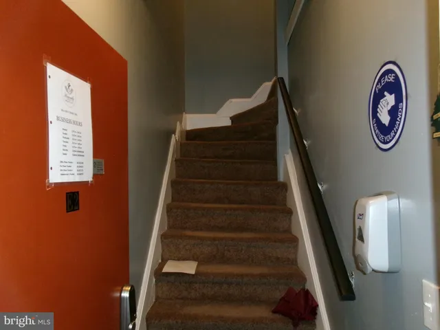 a view of a workspace with furniture and a flat screen tv