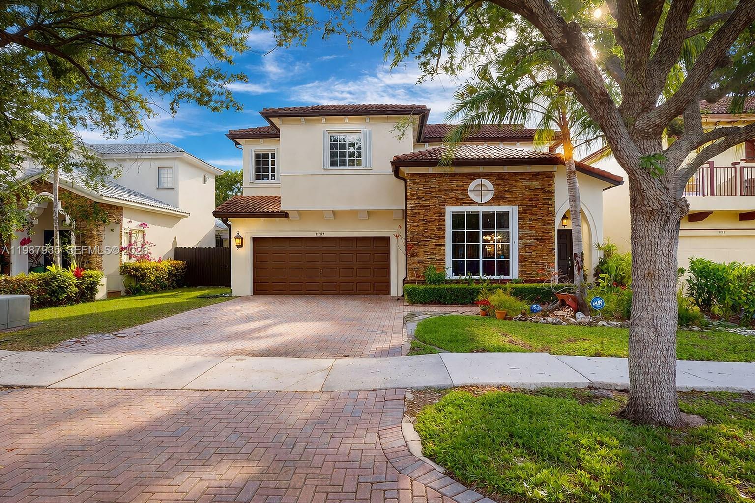 16479 Southwest 50th Terrace Miami, FL 33185 - Photo 1 of 51 a front view of a house with a yard and garage