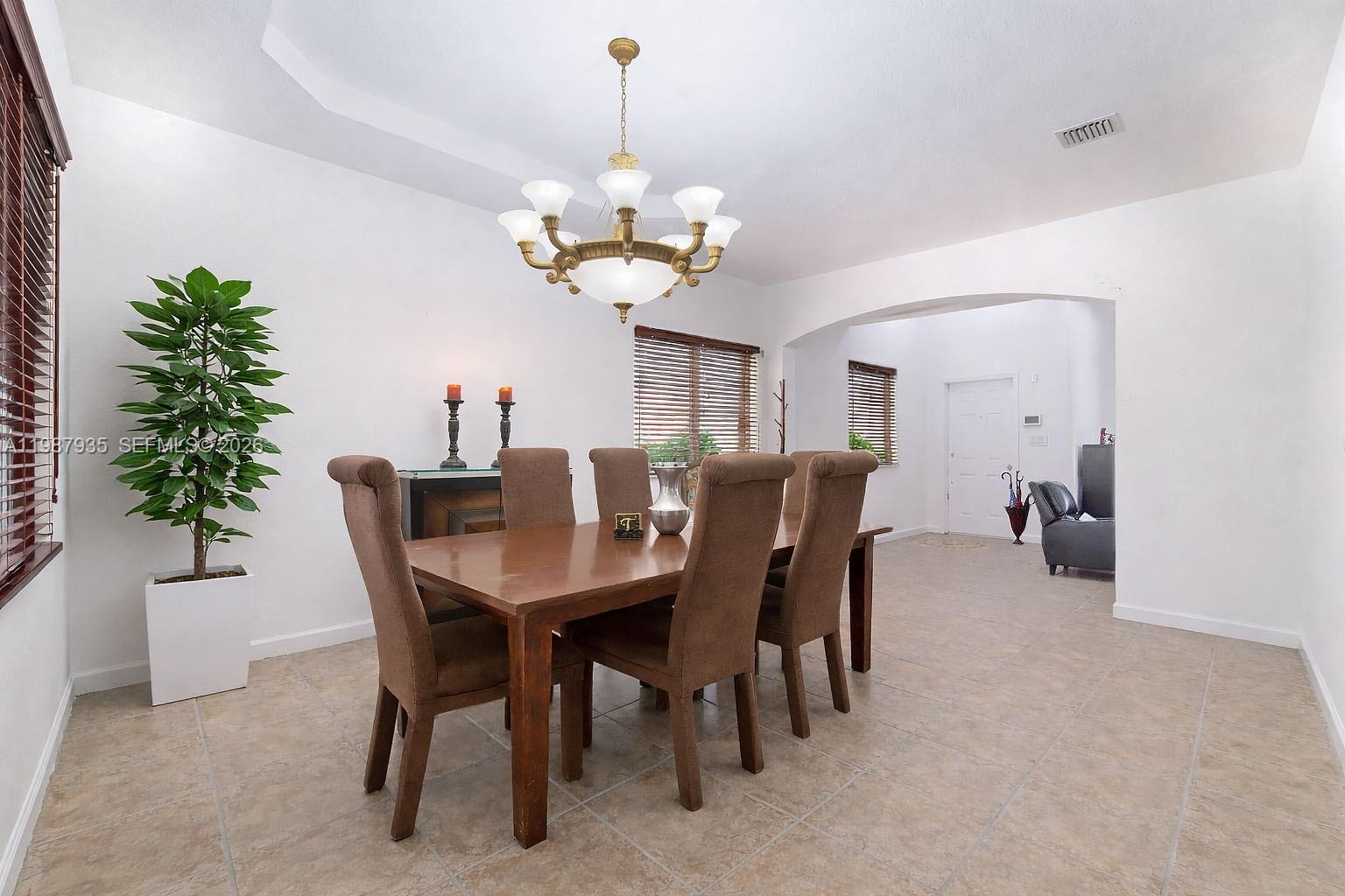 16479 Southwest 50th Terrace Miami, FL 33185 - Photo 12 of 51 a view of a dining room with furniture and chandelier