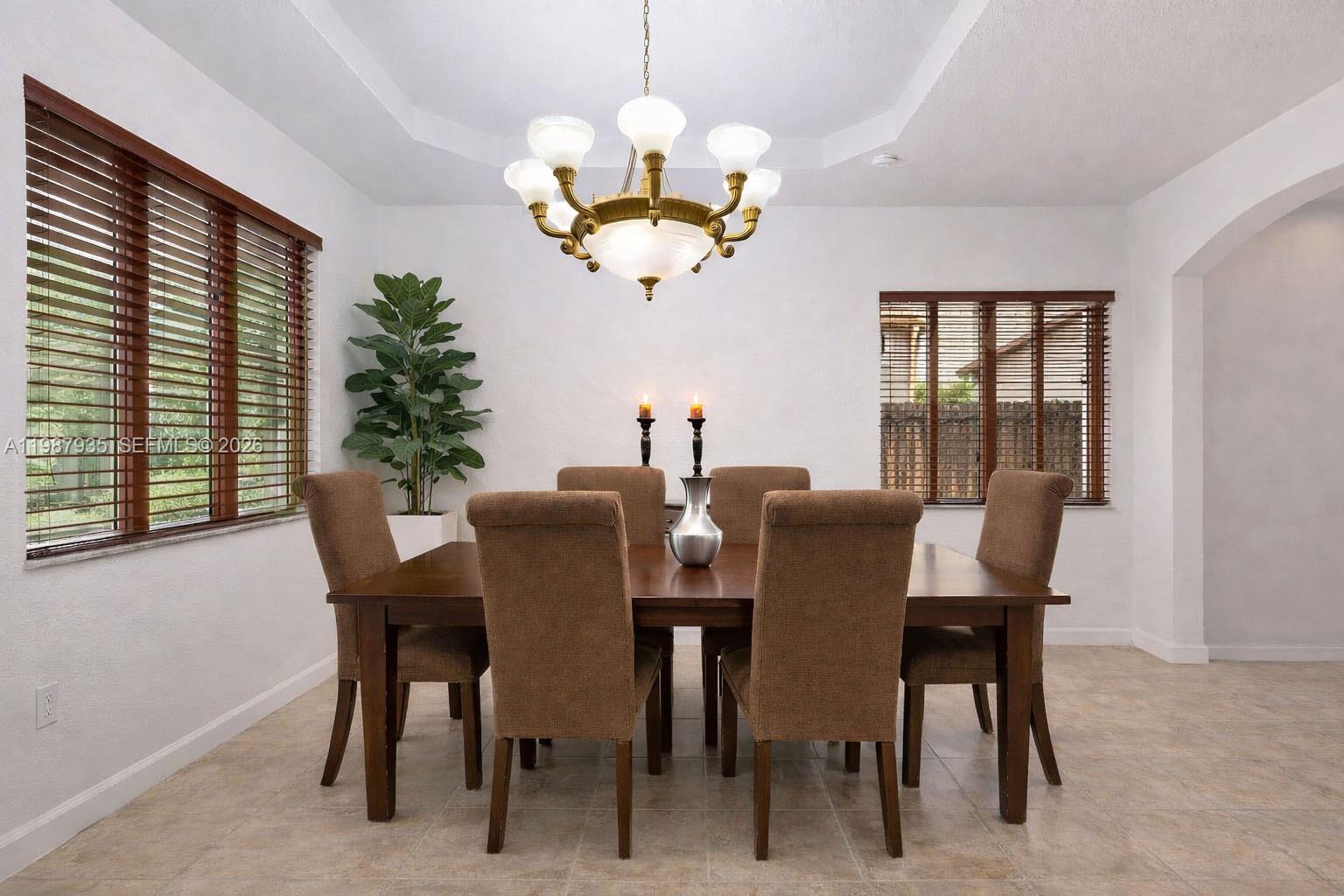 16479 Southwest 50th Terrace Miami, FL 33185 - Photo 13 of 51 a view of a dining room with furniture a chandelier and a window