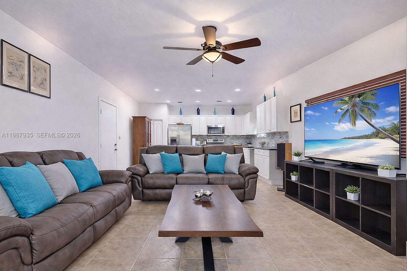 16479 Southwest 50th Terrace Miami, FL 33185 - Photo 16 of 51 a living room with furniture and a flat screen tv