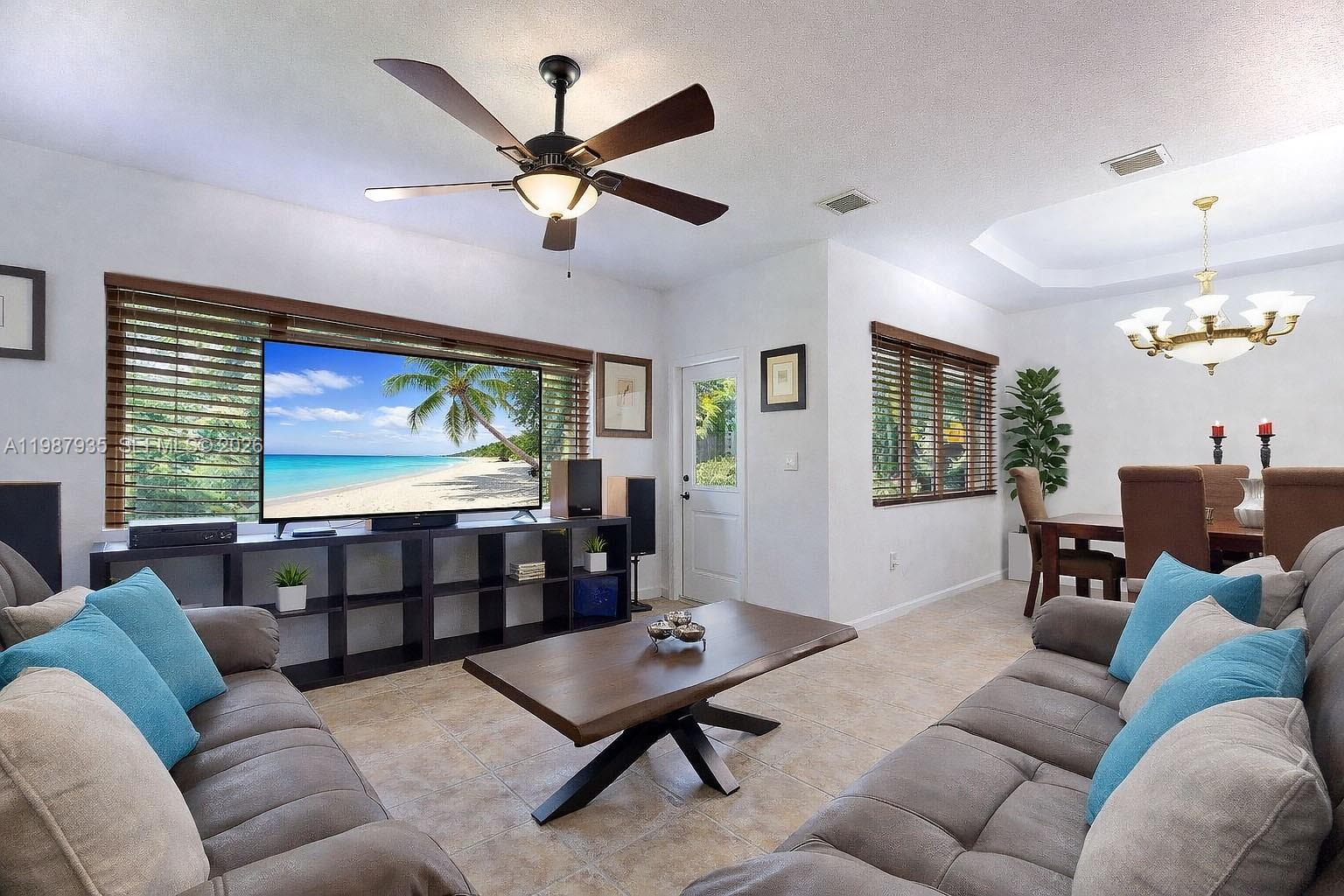 16479 Southwest 50th Terrace Miami, FL 33185 - Photo 17 of 51 a living room with furniture a ceiling fan and a window