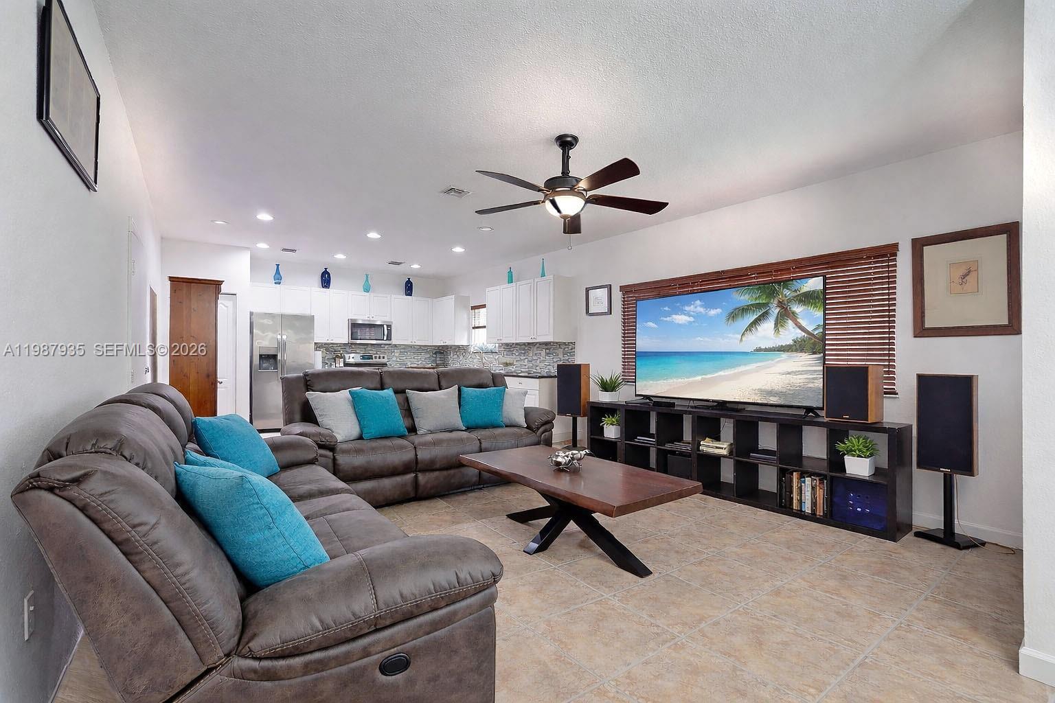 16479 Southwest 50th Terrace Miami, FL 33185 - Photo 18 of 51 a living room with furniture and a flat screen tv