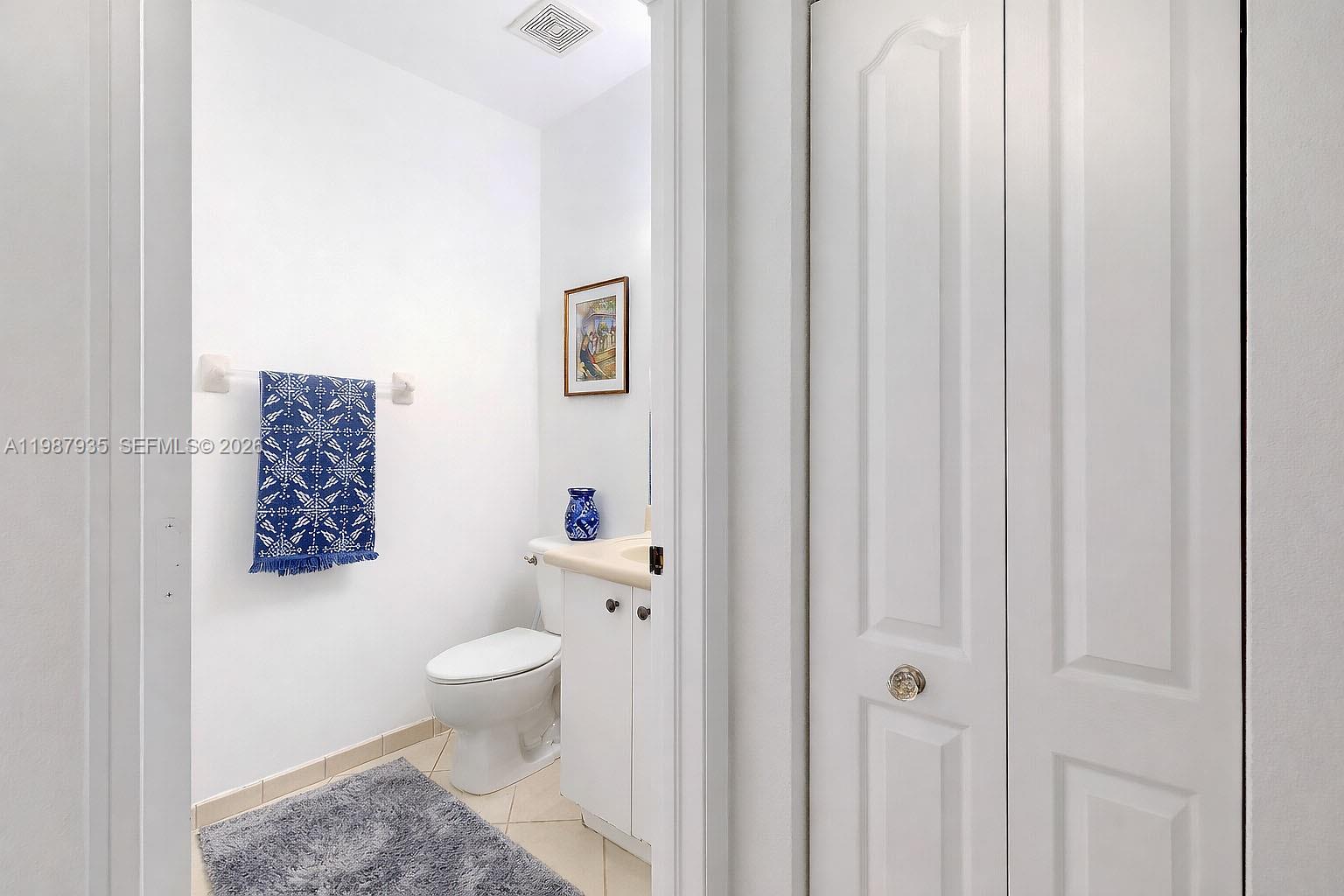 16479 Southwest 50th Terrace Miami, FL 33185 - Photo 24 of 51 a bathroom with a toilet and a shower curtain