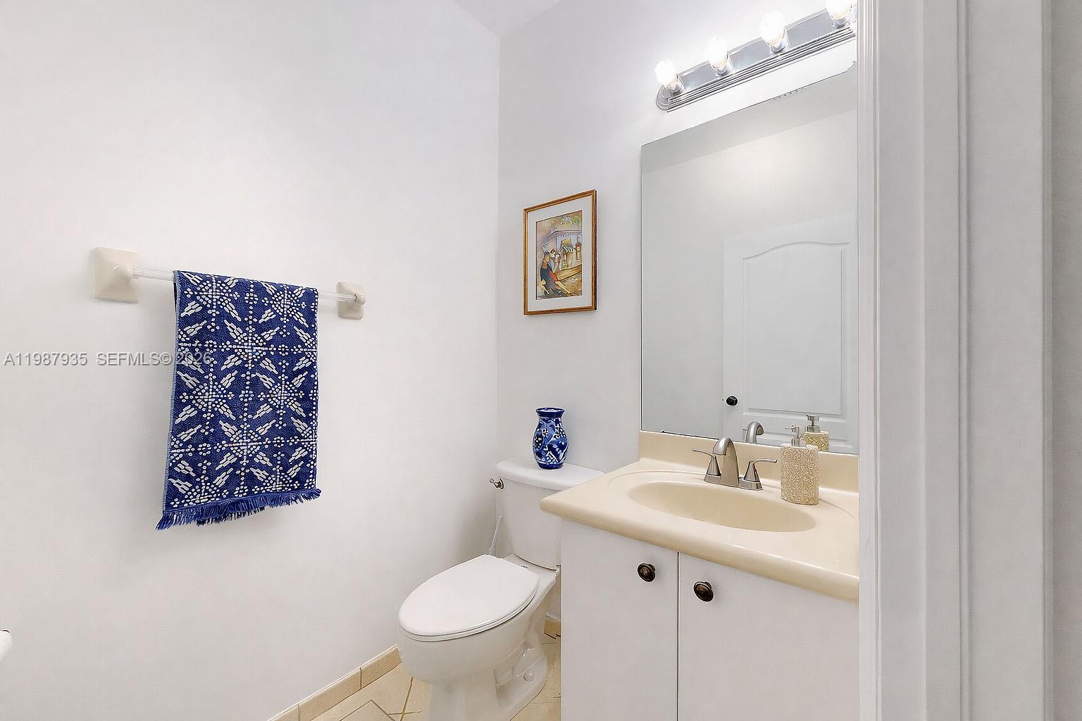 16479 Southwest 50th Terrace Miami, FL 33185 - Photo 25 of 51 a bathroom with a sink mirror and toilet