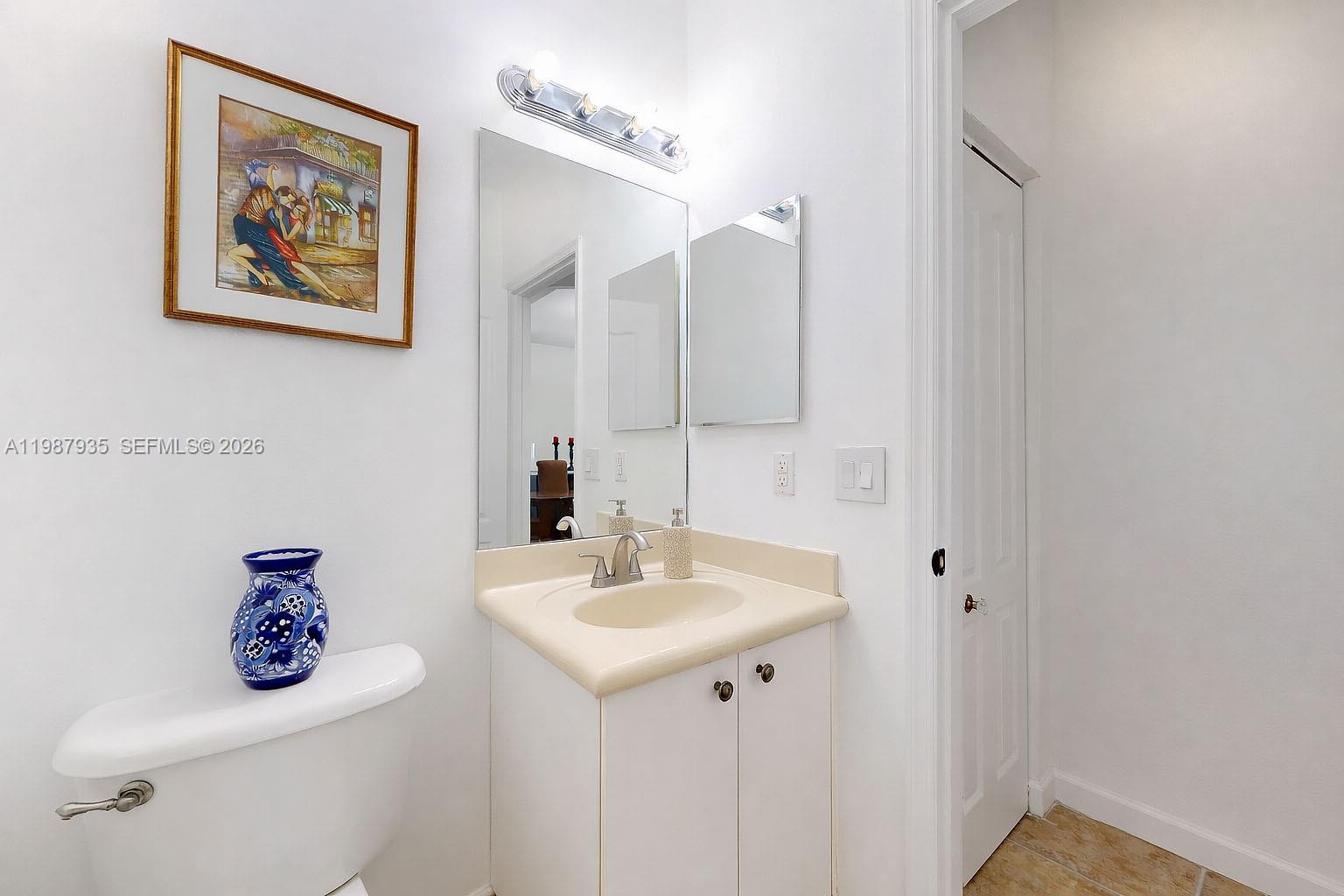 16479 Southwest 50th Terrace Miami, FL 33185 - Photo 26 of 51 a bathroom with a sink mirror and toilet