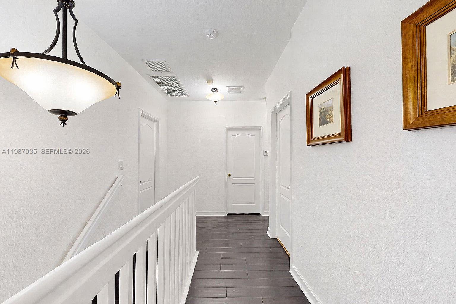 16479 Southwest 50th Terrace Miami, FL 33185 - Photo 27 of 51 a view of a hallway with wooden floor and entryway