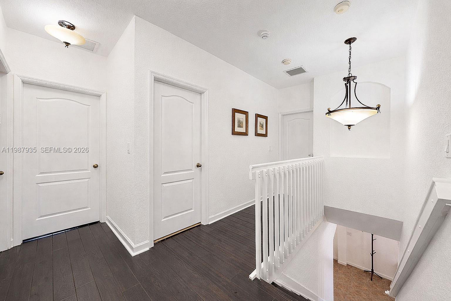 16479 Southwest 50th Terrace Miami, FL 33185 - Photo 28 of 51 a view of a hallway with wooden floor and staircase