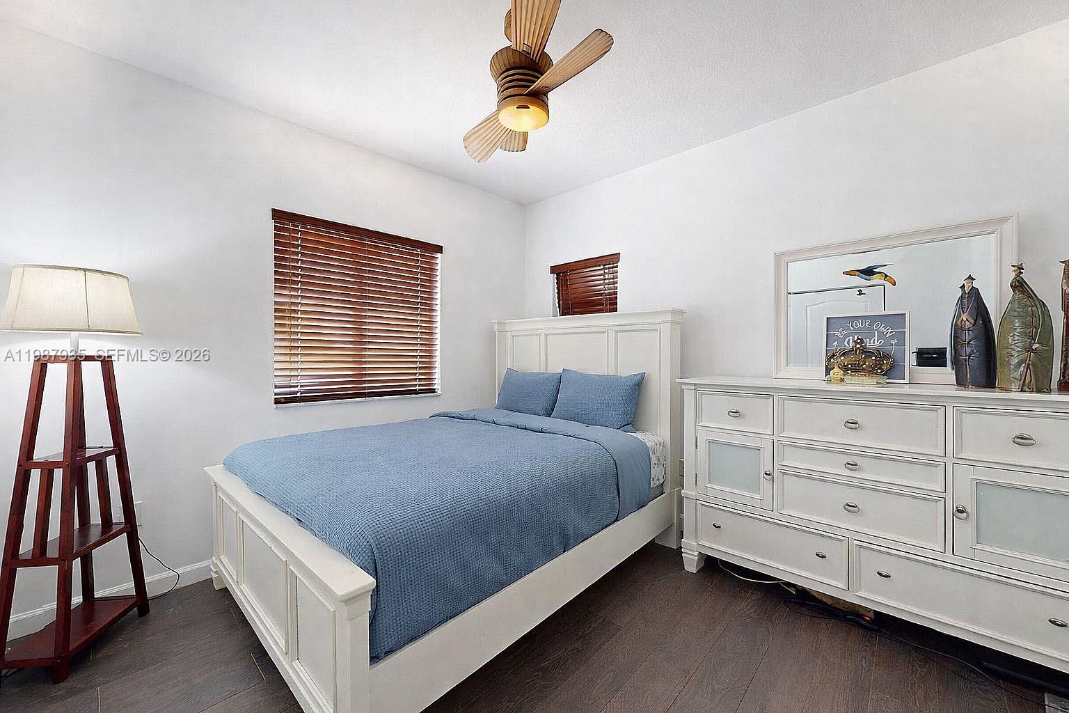 16479 Southwest 50th Terrace Miami, FL 33185 - Photo 31 of 51 a bed room with a bed and a night stand