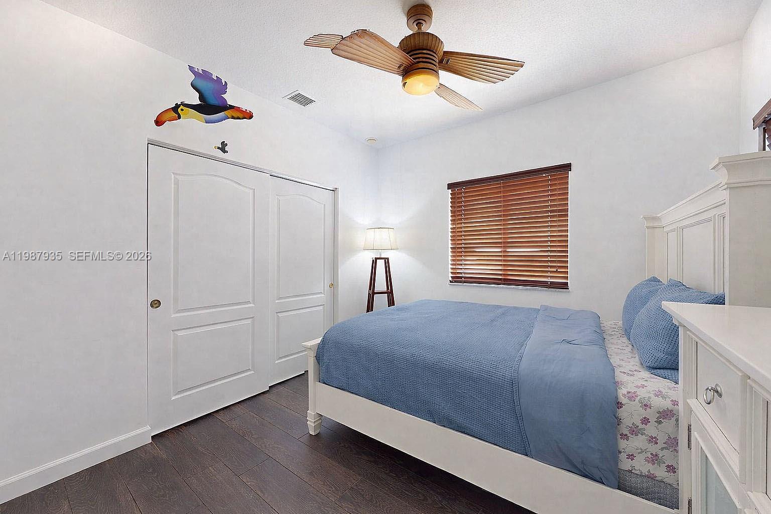 16479 Southwest 50th Terrace Miami, FL 33185 - Photo 32 of 51 a bedroom with a bed and a chandelier