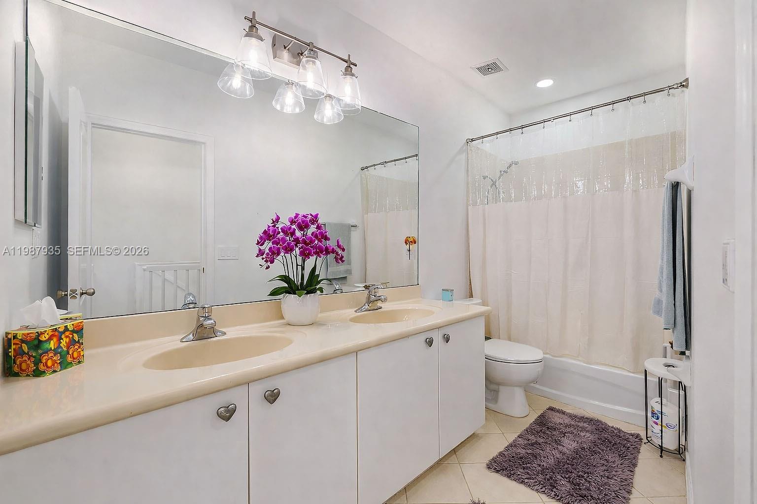 16479 Southwest 50th Terrace Miami, FL 33185 - Photo 33 of 51 a bathroom with a sink a toilet and a mirror