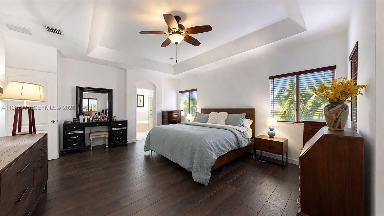 16479 Southwest 50th Terrace Miami, FL 33185 - Photo 35 of 51 a bedroom with a large bed a flat tv screen and dresser