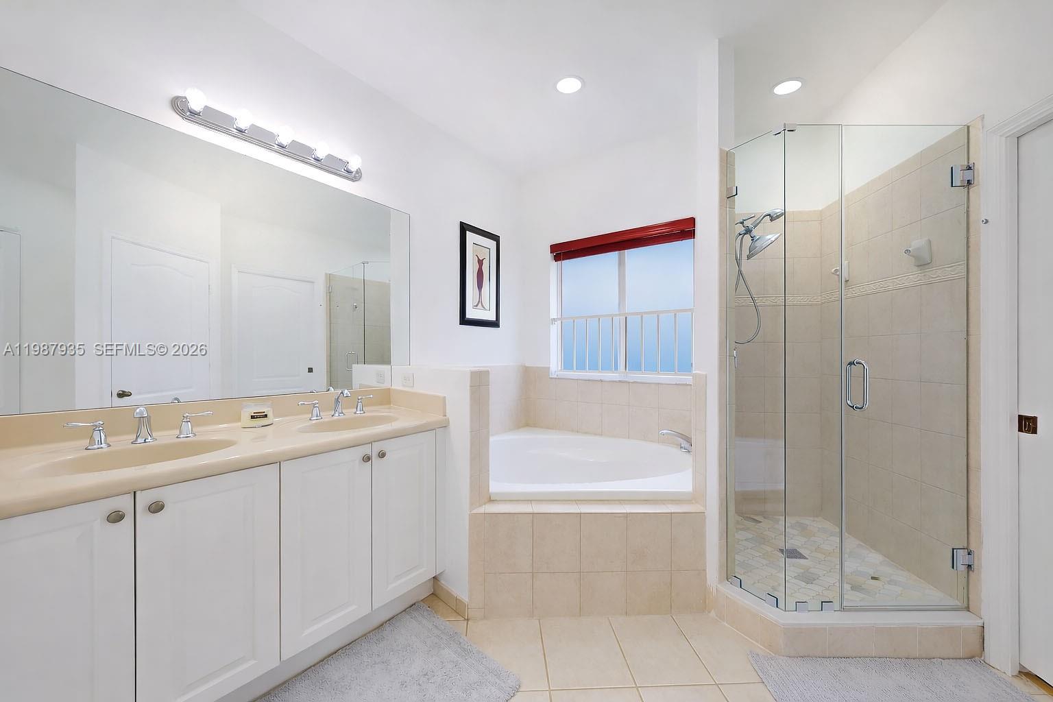 16479 Southwest 50th Terrace Miami, FL 33185 - Photo 39 of 51 a bathroom with a tub a sink shower and mirror