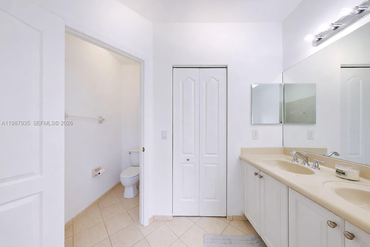 16479 Southwest 50th Terrace Miami, FL 33185 - Photo 40 of 51 a bathroom with a sink a toilet and a mirror
