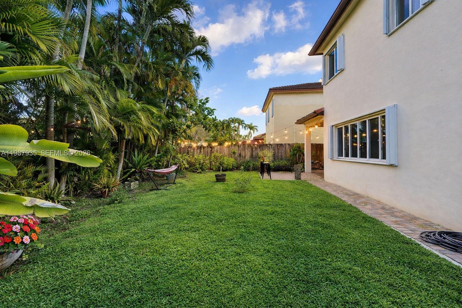 16479 Southwest 50th Terrace Miami, FL 33185 - Photo 45 of 51 a view of backyard with plants and outdoor seating