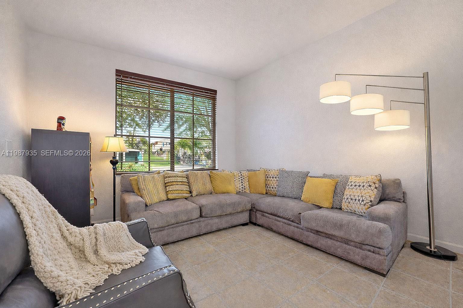 16479 Southwest 50th Terrace Miami, FL 33185 - Photo 8 of 51 a living room with furniture and a window