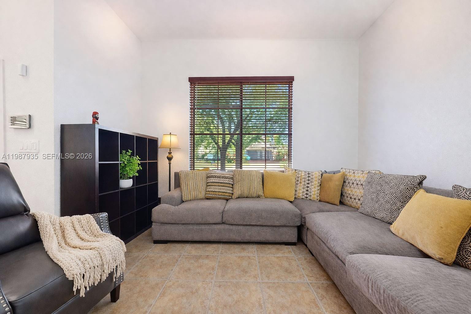 16479 Southwest 50th Terrace Miami, FL 33185 - Photo 9 of 51 a living room with furniture and a large window
