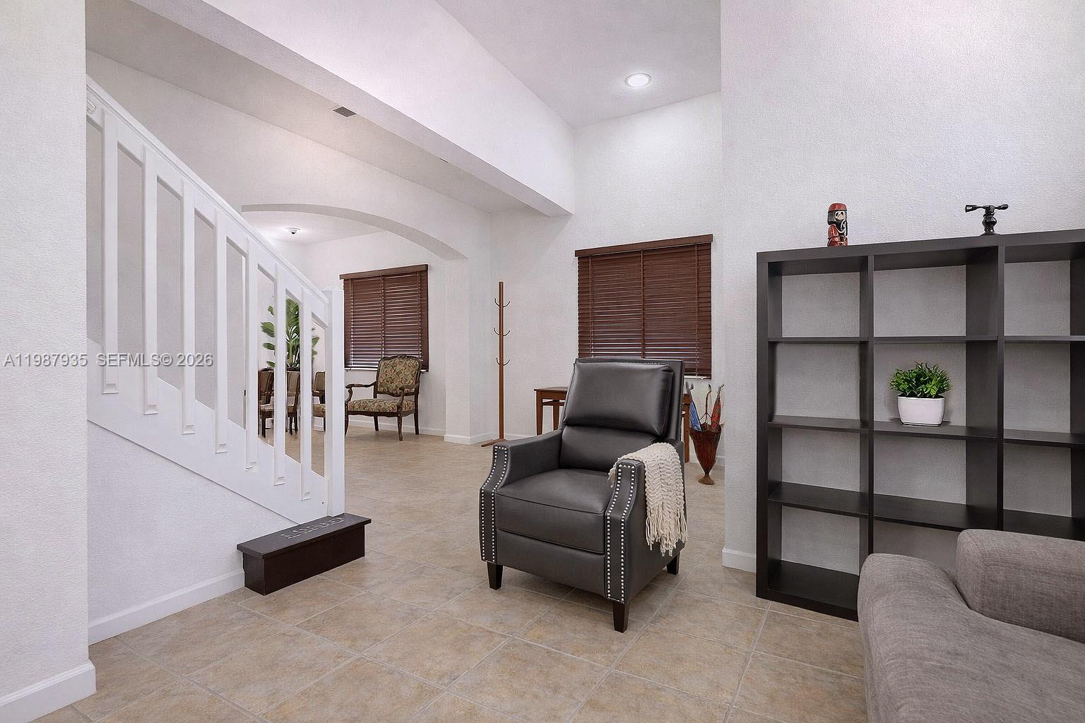 16479 Southwest 50th Terrace Miami, FL 33185 - Photo 10 of 51 a living room with furniture and a flat screen tv