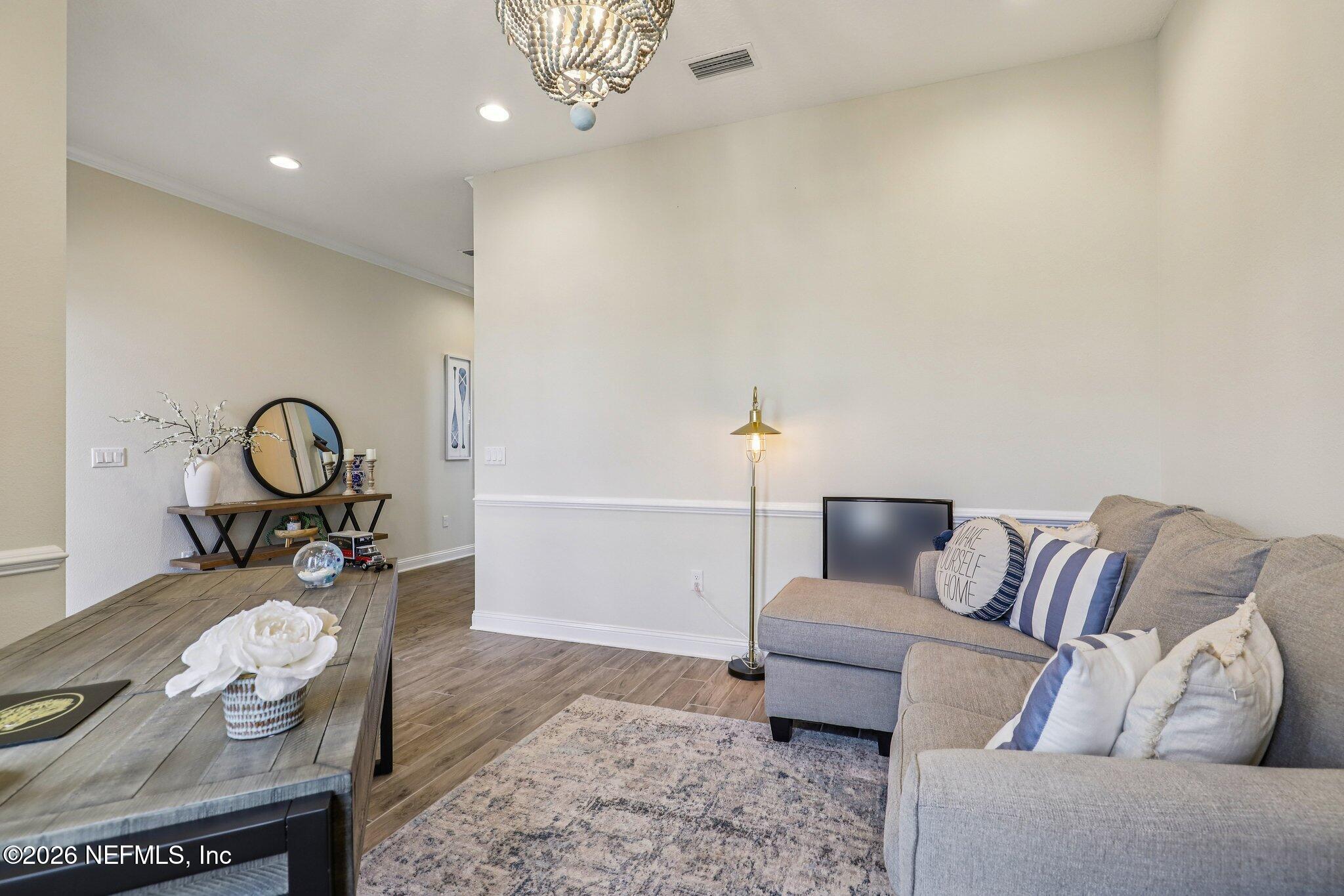 97 Rialto Drive Ponte Vedra, FL 32081 - Photo 9 of 48 a living room with furniture and a mirror