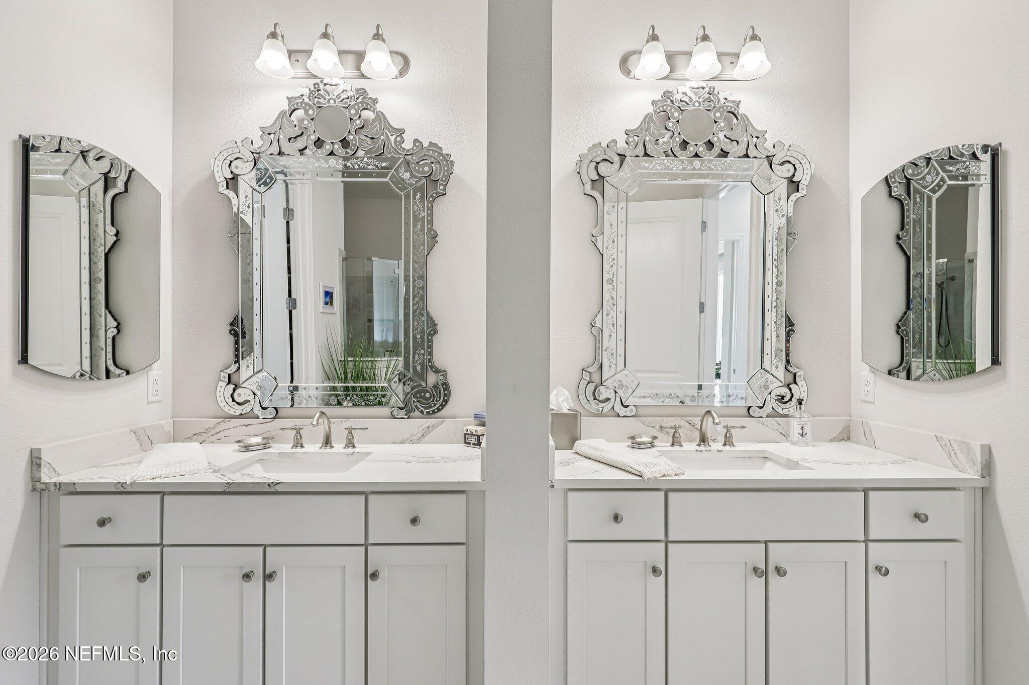 97 Rialto Drive Ponte Vedra, FL 32081 - Photo 15 of 48 a bathroom with double vanity sinks a vanity a mirror and a chandelier