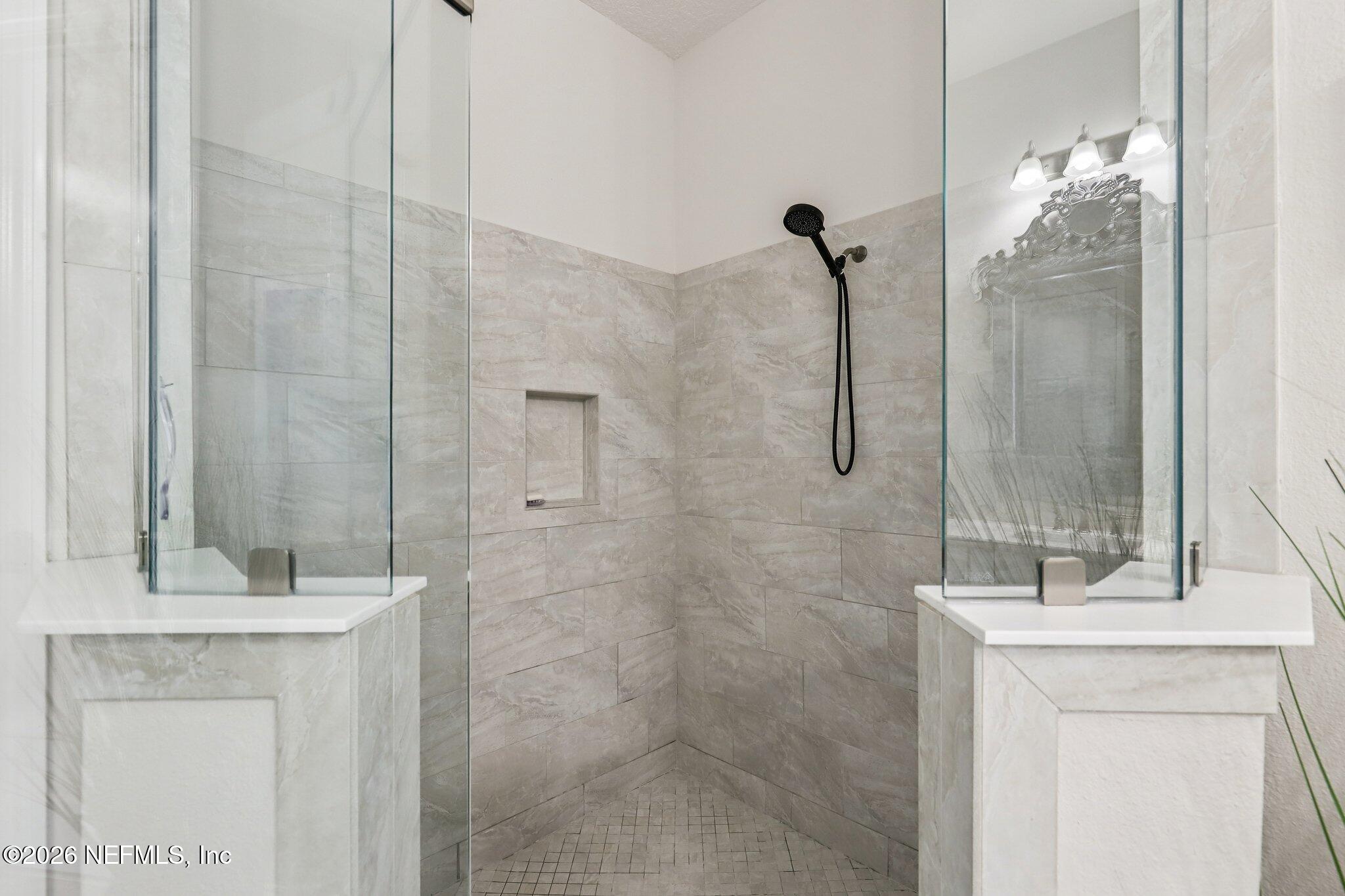 97 Rialto Drive Ponte Vedra, FL 32081 - Photo 17 of 48 a bathroom with a sink a mirror and shower