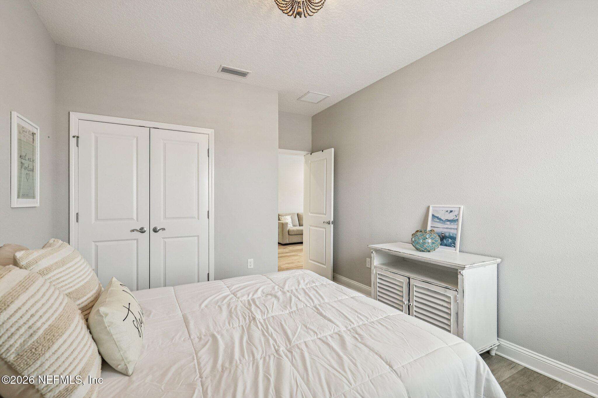 97 Rialto Drive Ponte Vedra, FL 32081 - Photo 25 of 48 a bedroom with a bed and cabinets