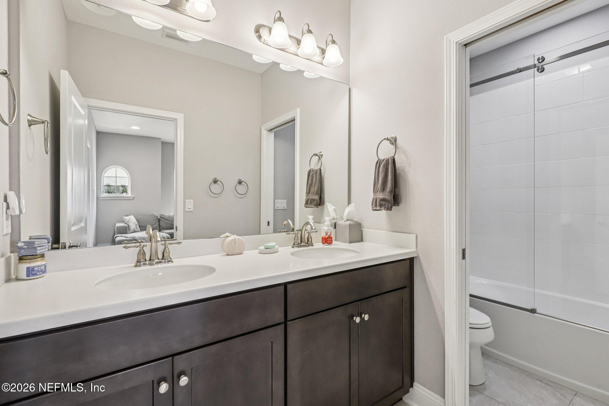 97 Rialto Drive Ponte Vedra, FL 32081 - Photo 26 of 48 a bathroom with a double vanity sink mirror and toilet