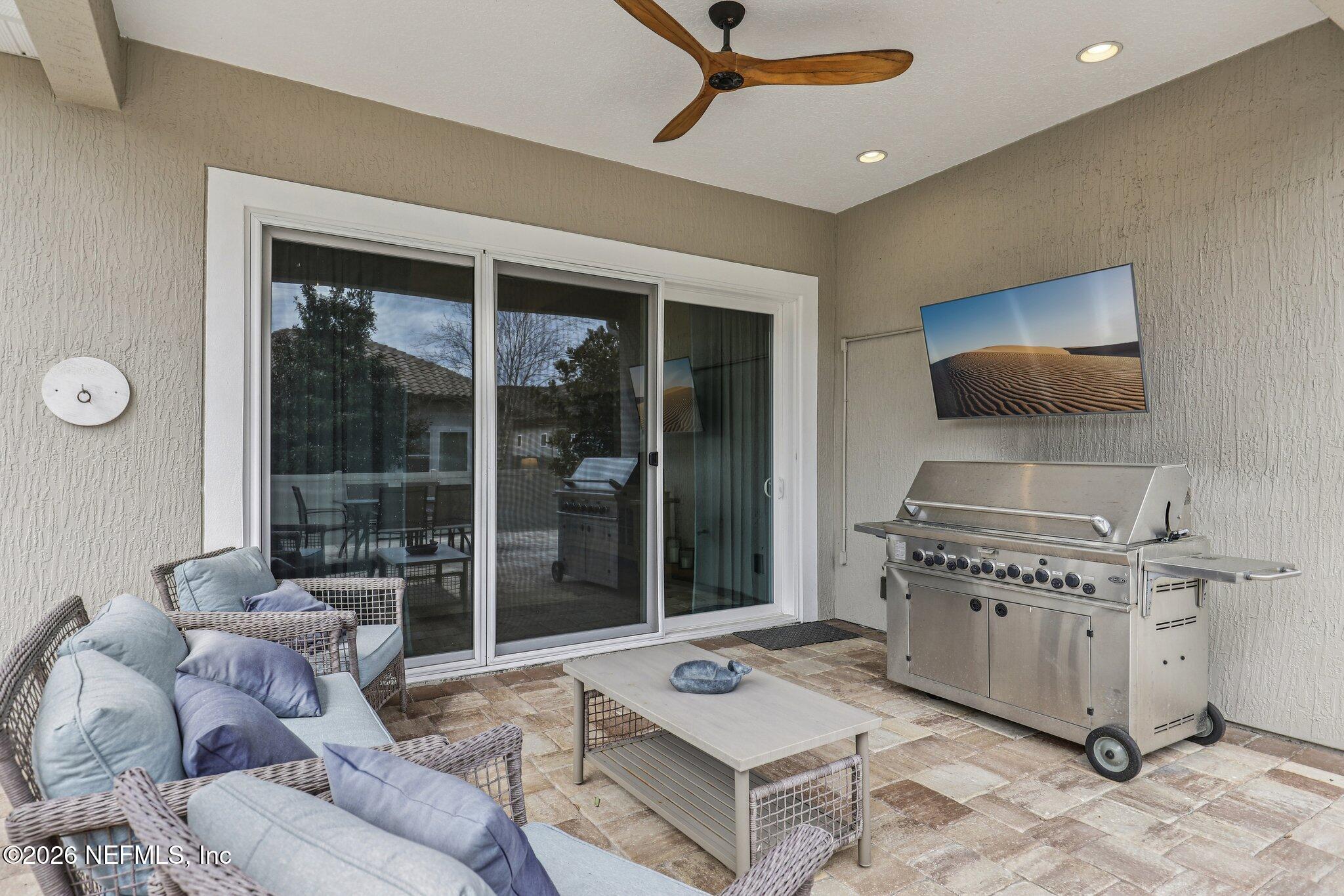 97 Rialto Drive Ponte Vedra, FL 32081 - Photo 28 of 48 a living room with furniture a floor to ceiling window and a flat screen tv