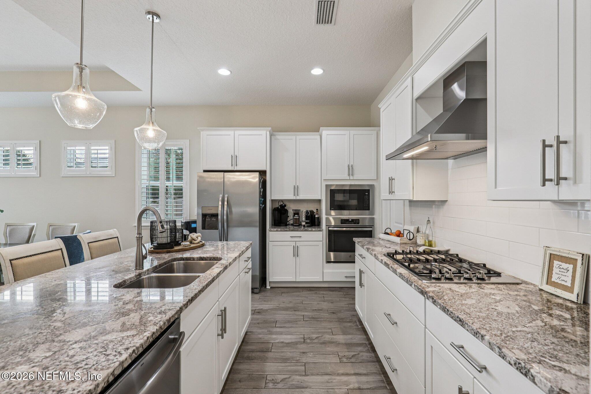 97 Rialto Drive Ponte Vedra, FL 32081 - Photo 4 of 48 a kitchen with stainless steel appliances granite countertop a sink a stove and a refrigerator