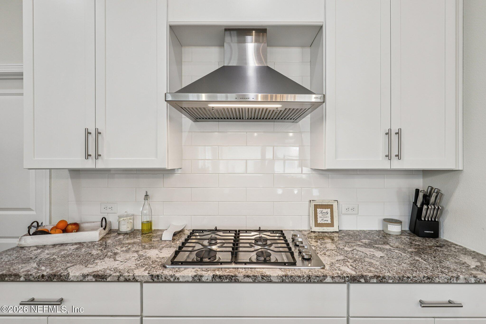97 Rialto Drive Ponte Vedra, FL 32081 - Photo 7 of 48 a kitchen with granite countertop a stove sink and cabinets