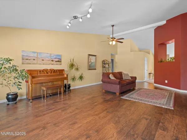 a living room with furniture and a piano