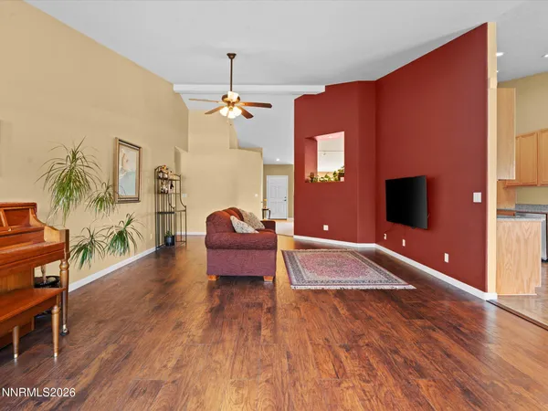 a spacious bedroom with wooden floor and furniture