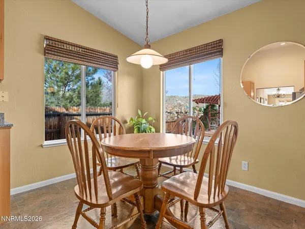 a dining room with furniture a chandelier and window