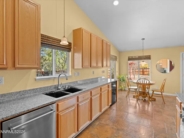 a kitchen with stainless steel appliances granite countertop a stove refrigerator and cabinets