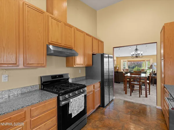 a spacious bedroom with a large bed and a chandelier
