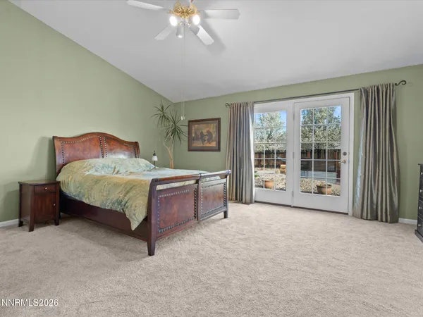 a spacious bedroom with a bed and a table in it